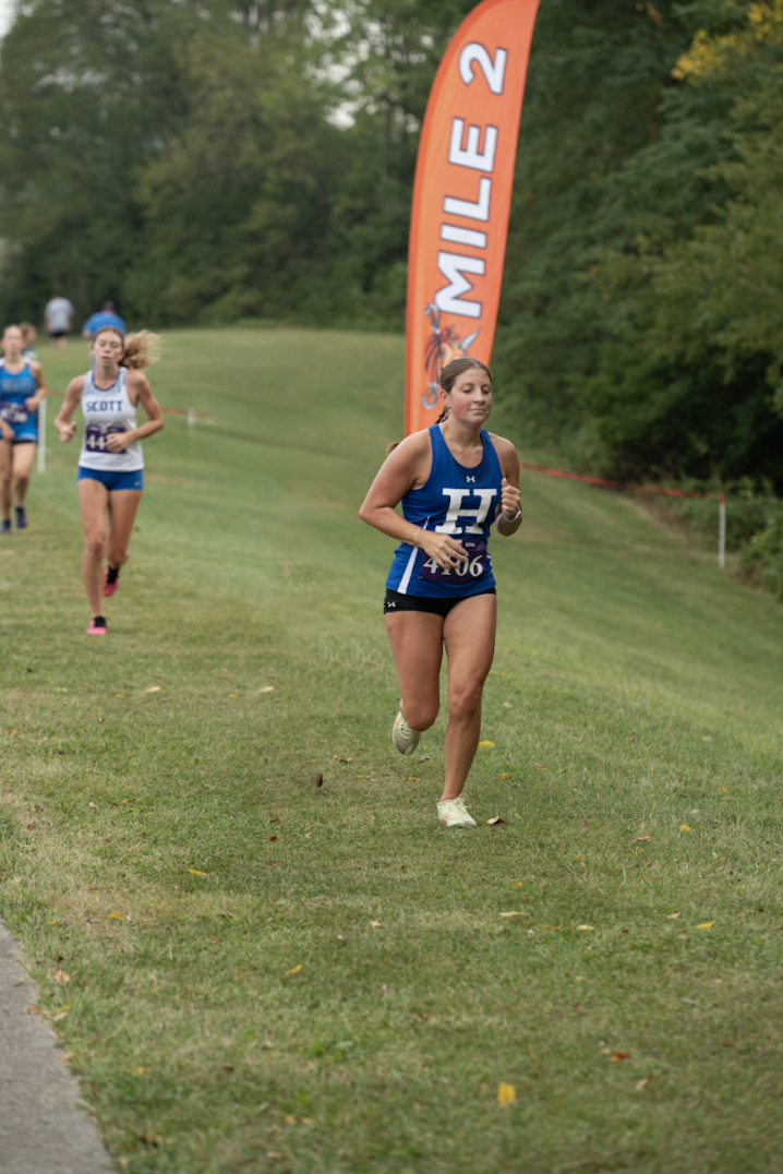 Sarah Jones (12) runs past the 2 mile marker. Jones said, "I love running because I get to spend time with friends I don't normally get to talk to in school."